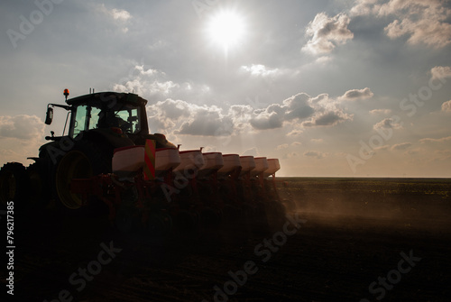 Farmer with tractor seeding in sunset © Dusan Kostic