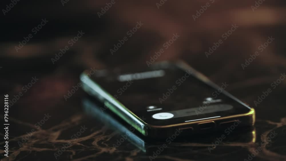 A cell phone ringing on call aslaying on a table