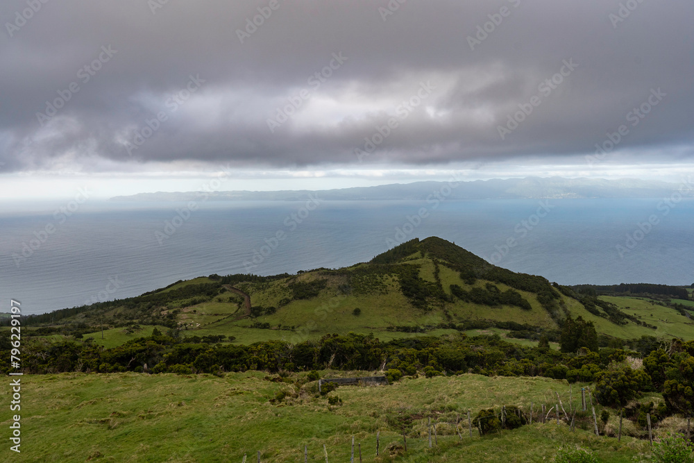 Pico Island. Azores. Amazing panoramic view of Pico Island in spring. Green mountains and the Atlantic coast. Waves. Beautiful landscape.