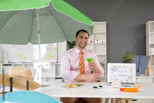 Happy male office worker wi...