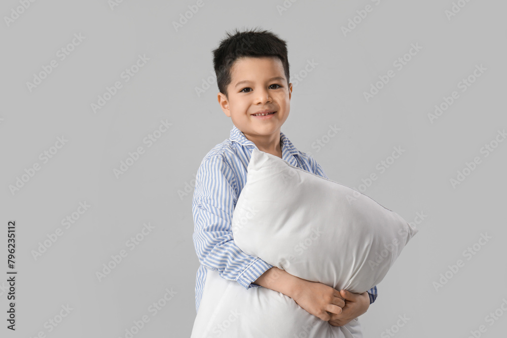 Cute little Asian boy in pajamas with pillow on white background Cute little Asian boy in pajamas with pillow on white background