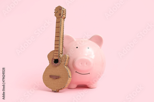 Piggy bank with toy guitar ...