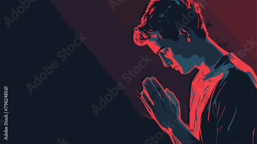 Praying young man on dark background 