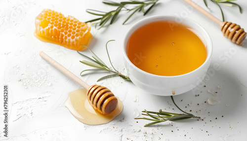 Bowl of sweet honey, dippers and combs on white background © Oleksiy