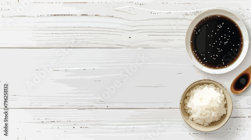 Plate with boiled rice and soy sauce on white wooden photo