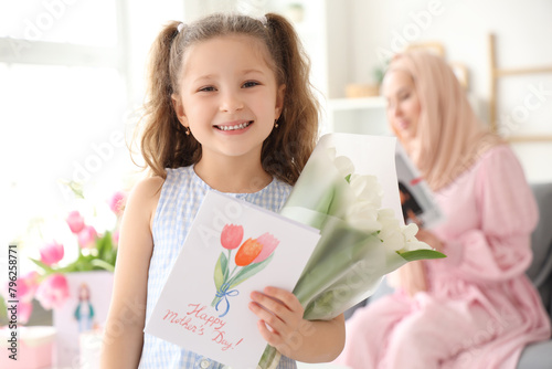 Little girl with tulips and...