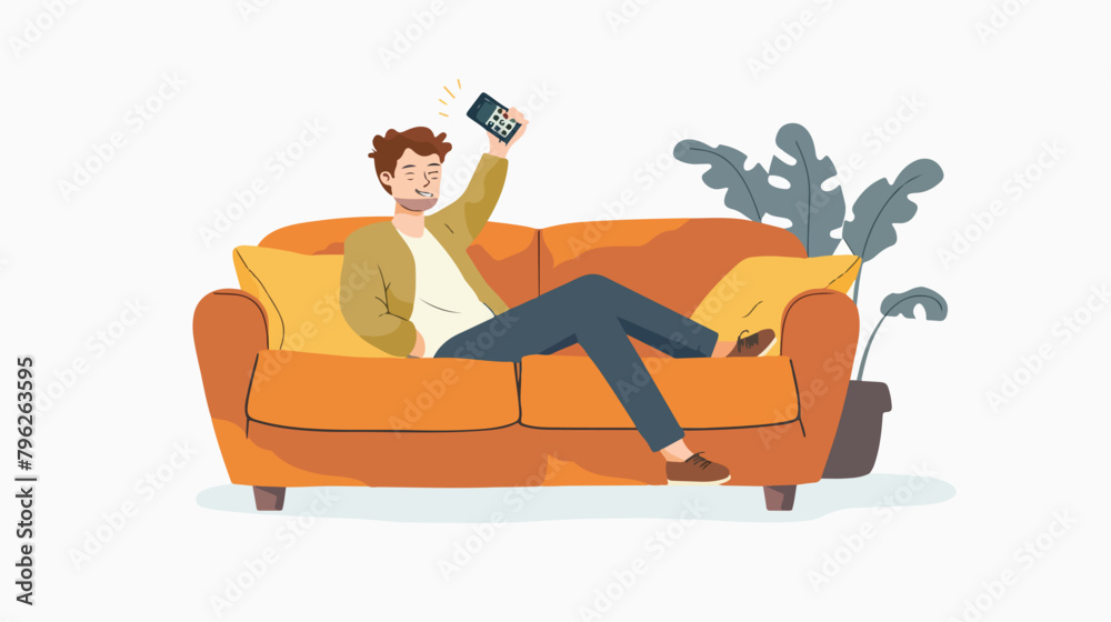 Young man with TV remote control lying on sofa isolated