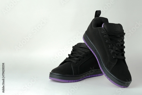 Black sport shoes on white background with copy space, close-up.