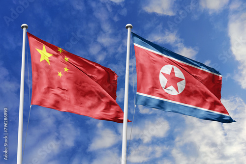 3d illustration. China and North  Korea, Flag waving in sky. High detailed waving flag. 3D render. Waving in sky. Flags fluttered in the cloudy sky. photo