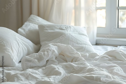 Messy white bedding with pillows in background. Concept Bedroom Decor, Interior Design, Cozy Spaces, White Aesthetics photo
