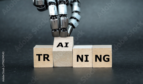 Robot Hand turns wooden cube and puts the letters AI (artificial intelligence) to the word training.