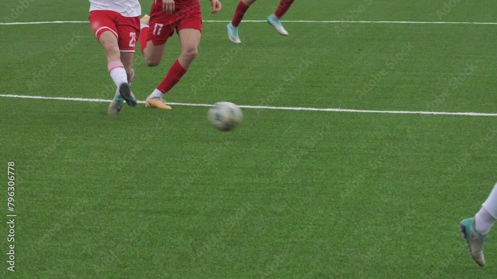 Legs of Professional Soccer Players Leading with a Ball on Stadium Legs of Professional Soccer Players Leading with a Ball on Stadium