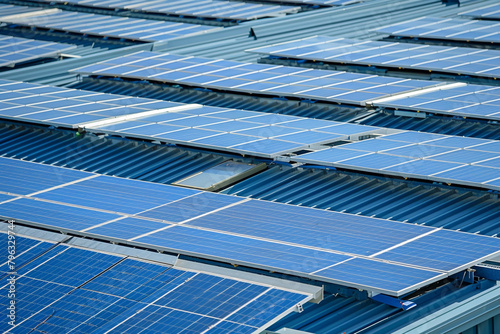 The rooftop of a warehouse adorned with solar panels, contributing to a reduction in greenhouse gas emissions.