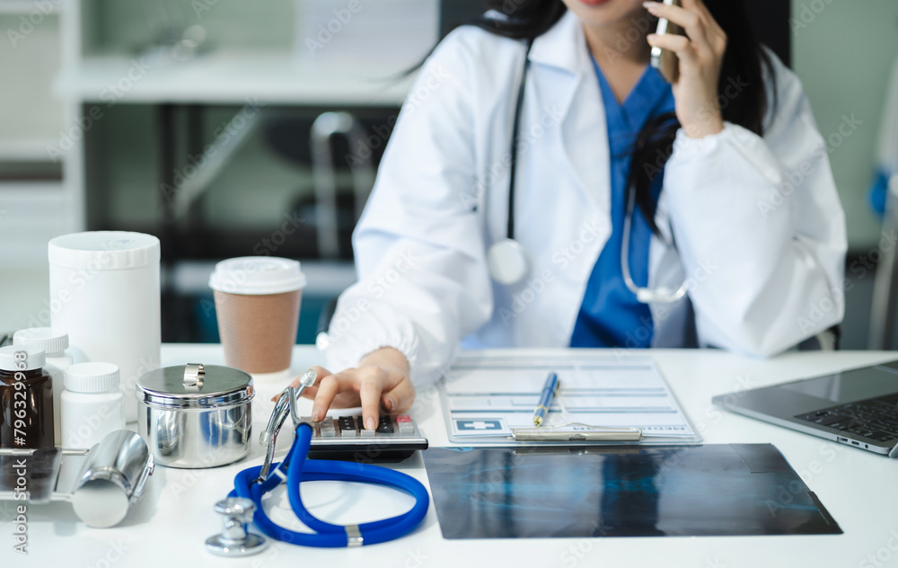 Doctor used a calculator, conduct financial transactions via tablets and data documents, put on the desk in the morning.