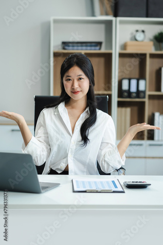 Happy young Asian woman presenting or showing open hand palm, happy working.