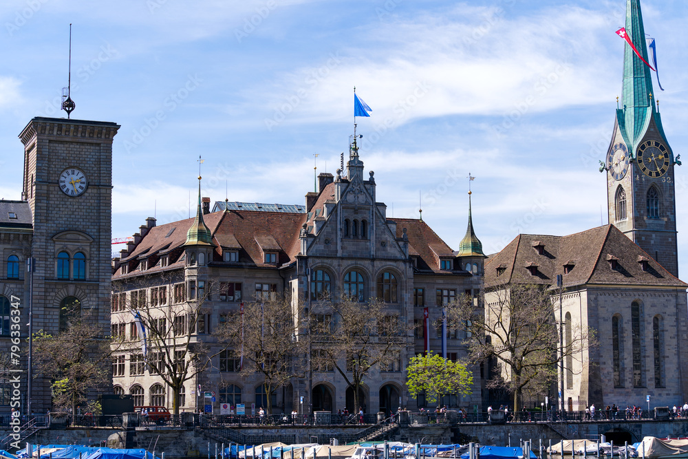 Skyline of the old town of Swiss City of Zürich with flying flags at famous spring festival named Sechselätuen on a sunny spring day. Photo taken April 14th, 2024, Zurich, Switzerland.