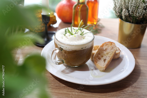 Mushroom soup. Bolete mushrooms cream with rosemary and garlic foam, served with toast with olive oil. 