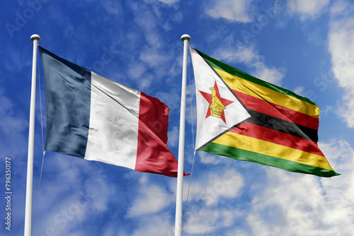 3d illustration. France and Zimbabwe Flag waving in sky. High detailed waving flag. 3D render. Waving in sky. Flags fluttered in the cloudy sky.