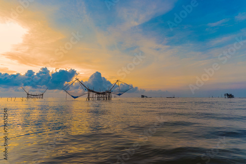 Sunrise and silhouette image of giant fishing net in the morning at Pakpra, Phatthalung, Thailand..