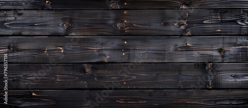 a black wood planks with knots photo