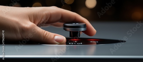 Close-up of hand pressing the button on a turntable