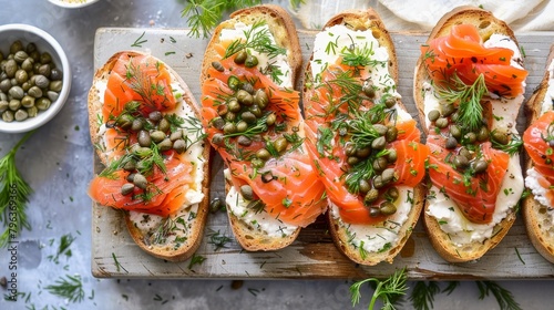 A plate of bread with salmon and capers on top