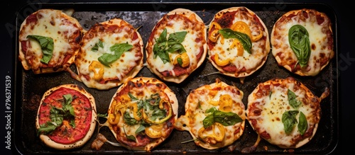 A panoramic shot of a variety of pizzas topped with cheese and fresh spinach