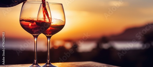 Pouring wine into glass sunset table