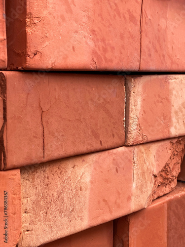 Stack of red clay bricks close-up