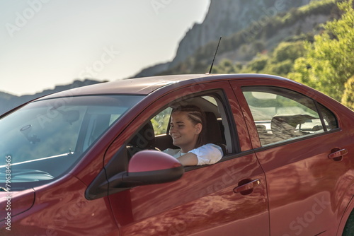 Woman driving a car. A lady in sunglasses takes the wheel of her © svetograph