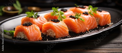 Salmon and caviar on plate with black backdrop photo