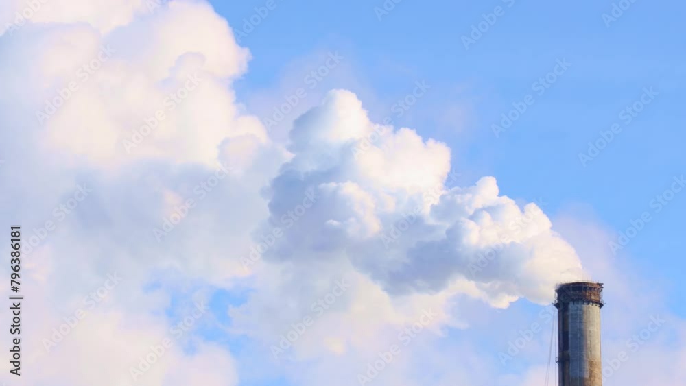 Thermal power station pipes gas and smoke emissions agaist the blue sky. Air pollution, environmental contamination concept Thermal power station pipes gas and smoke emissions agaist the blue sky. Air pollution, environmental contamination concept
