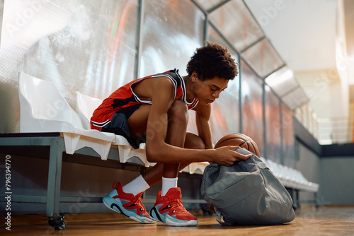Young black basketball player preparing for sports training. photo