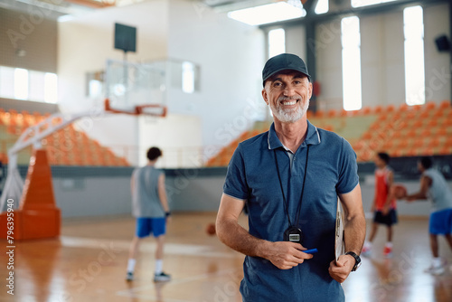 Bilde på lerret Happy basketball coach on court looking at camera.