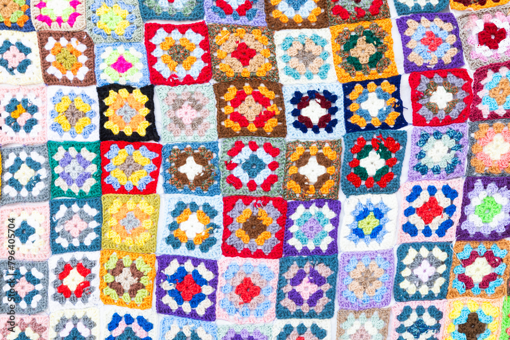 Fototapeta premium Multi colored blanket in wool, square geometric background, retro decorative pattern