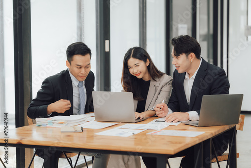 Young multiethnic diverse creative asian group huddle and high five hands together in office workshop with success or empower expression in teamwork. Young asian marketing team with copy space