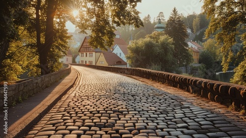 A winding road lined with towering trees leads to a picturesque cobblestone bridge over a serene river. Its the perfect spot for a . AI generation.