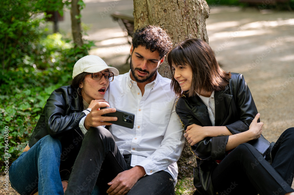 three friends taking pictures with their cell phones three friends taking pictures with their cell phones