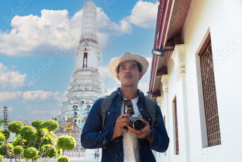 Photography Young Asian traveling backpacker taking photos with camera in Wat Arun in Bangko