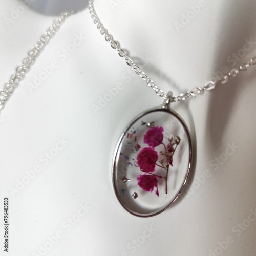 DIY costume jewelry made of epoxy resin and natural flowers, DIY jewelry master. Beautiful earrings and pendants made at home from jewelry resin. photo