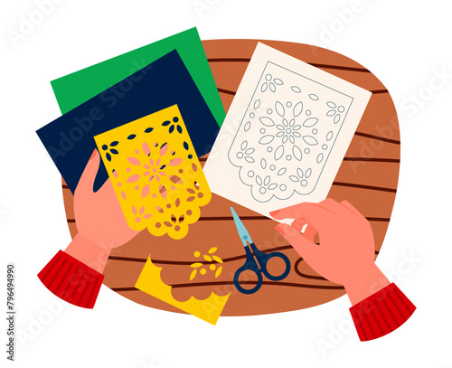 Cartoon vector illustration of hands cutting papel picado. Female hands holding yellow festive grid card  with flower abstract illustration. Top view of mexican craft hand made