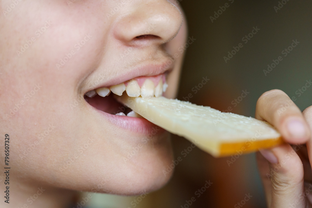 Happy anonymous teenage girl eating fresh cheese slice Happy anonymous teenage girl eating fresh cheese slice