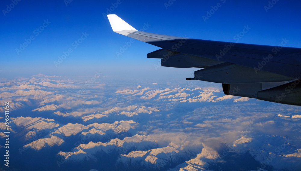 Fototapeta premium Swiss Alps and Airbus A340 313 wing early morning
