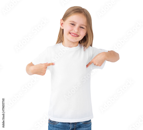 Little kid girl pointing on a blank white t-shirt isolated on white background