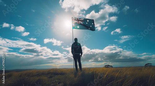 A person holding the Australian flag, viewed from the back, symbolizing patriotism and national pride.