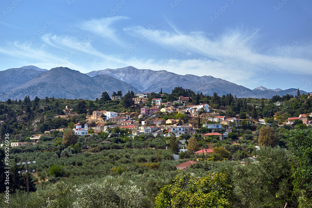 A town in the valley and rocky peaks in the Lefka Ori mountains on the island of Crete