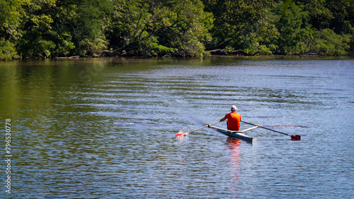 Rowing alone on the Charles River in a single scull boat, in Watertown, MA, USA
