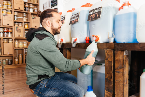 Bilde på lerret Man Refilling Reusable Container With Soap at a Zero Waste Grocery Store