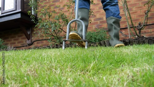 Aerating a lawn in spring with a lawn aeration tool