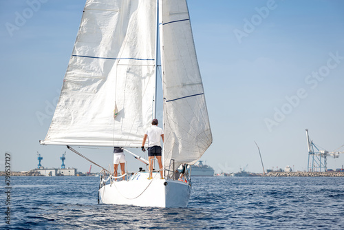 Crew on sailboat in a calm sea